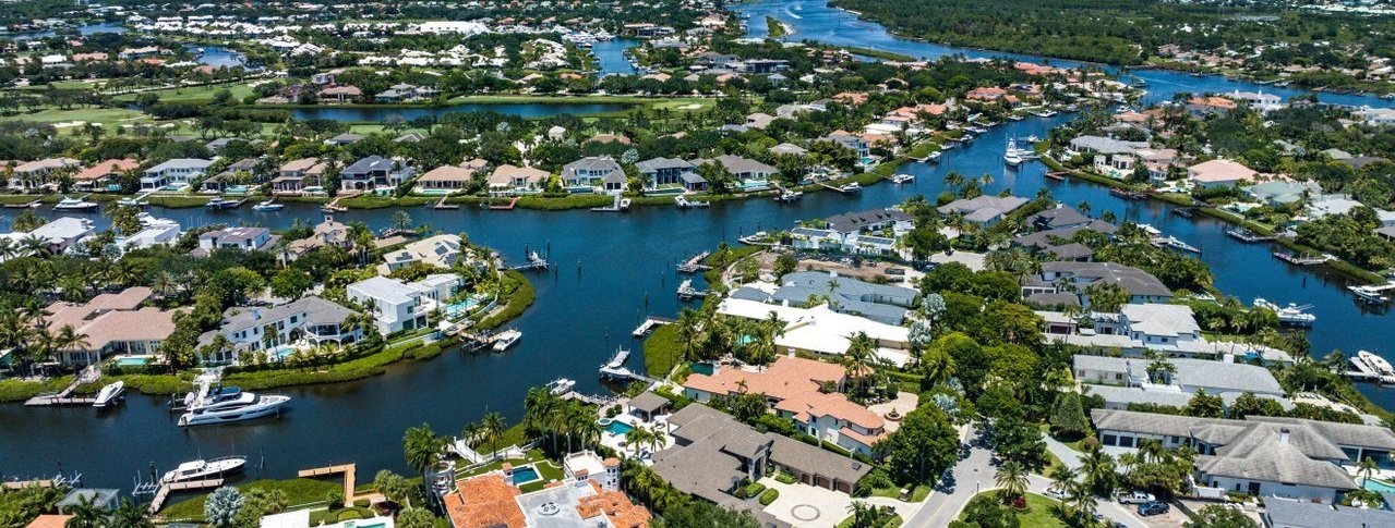 A golf course beside canal-front homes in Jupiter
