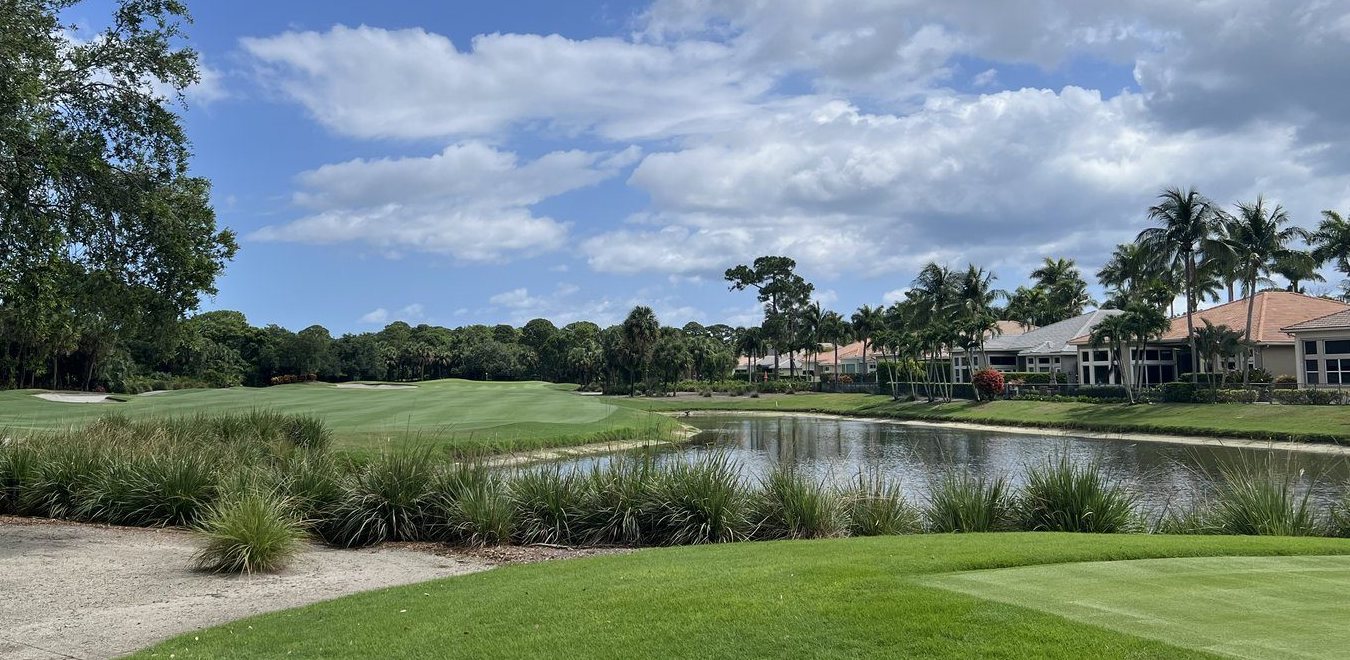 A golf hole and pond with homes beyond, Palm Beach Gardens