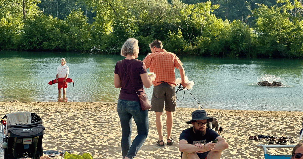 A dog on a leash with their owners.