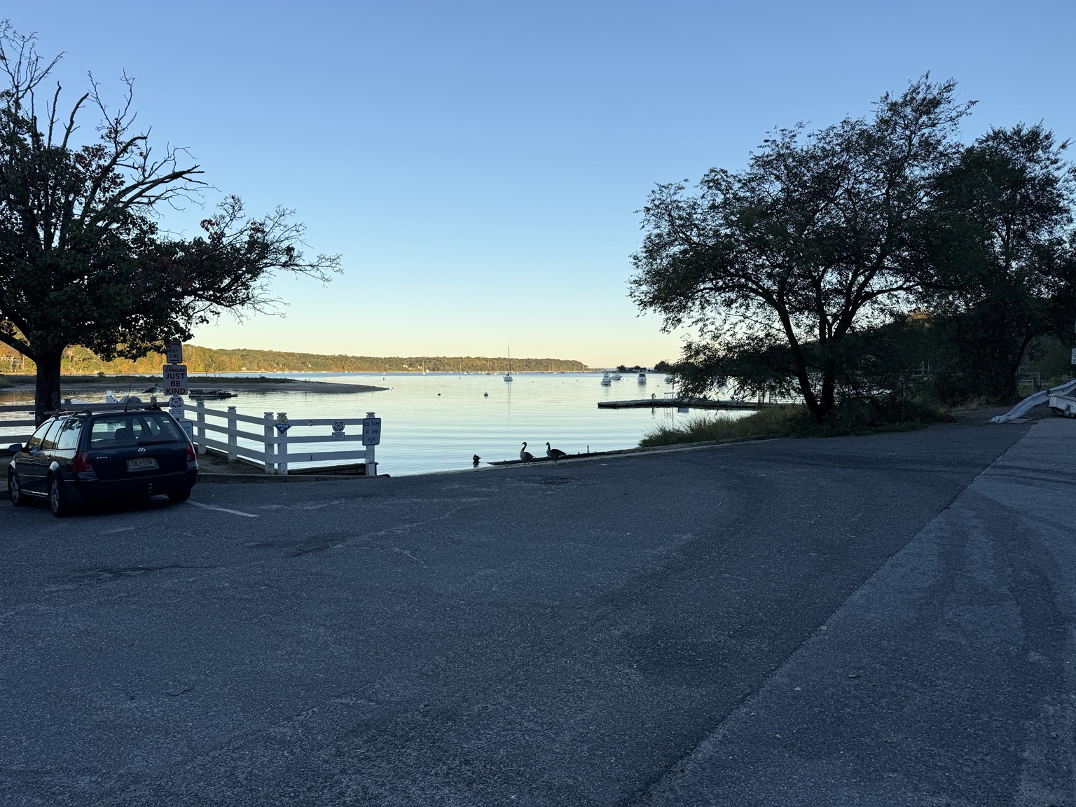 Peaceful Cold Spring Harbor waterfront with moored boats and wooded shoreline