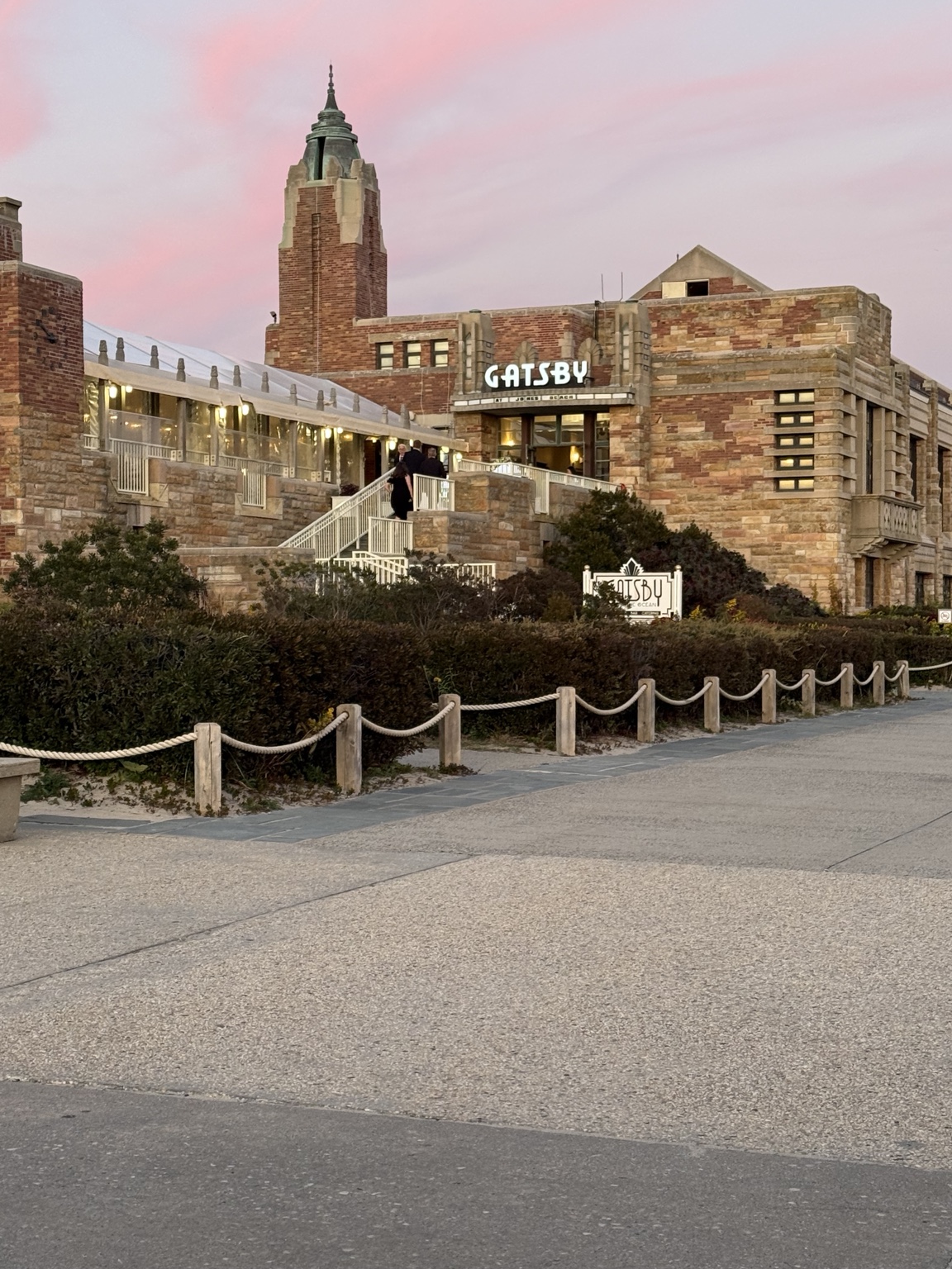 Gatsby on the Ocean at the Jones Beach West Bathhouse beneath a pink evening sky