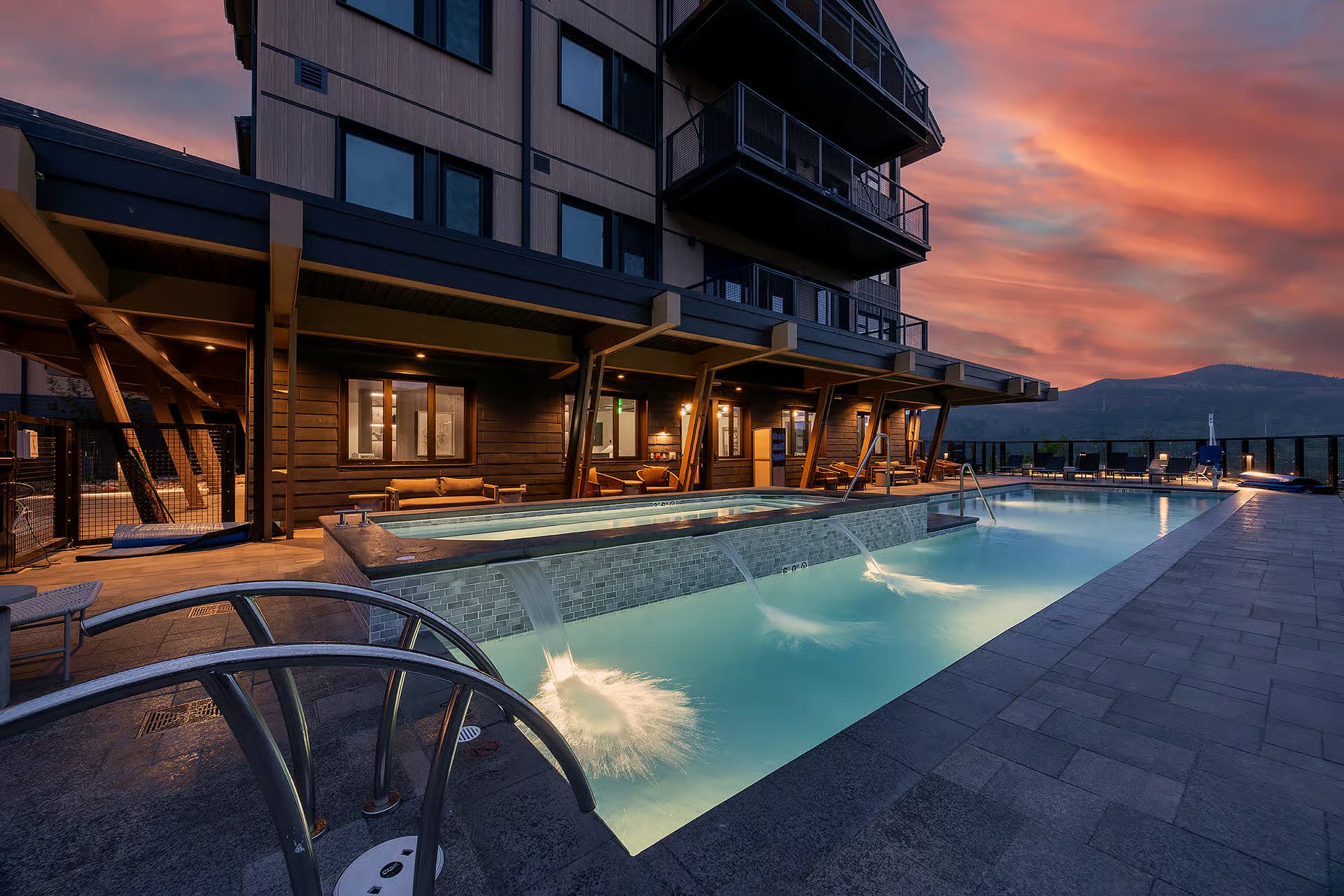 Completed Amble outdoor pool illuminated at dusk