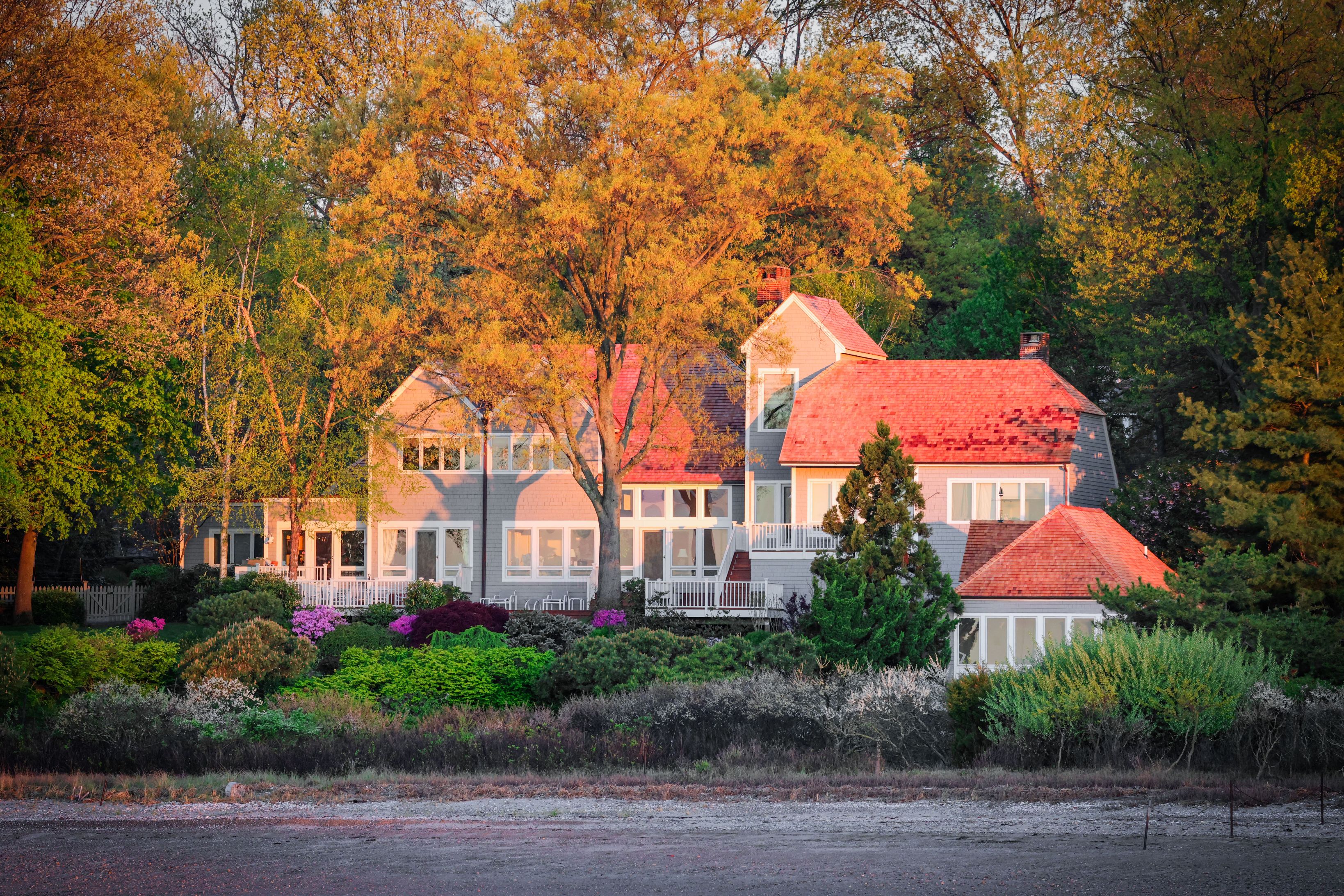 residential house among trees in autumn foliage and a garden
