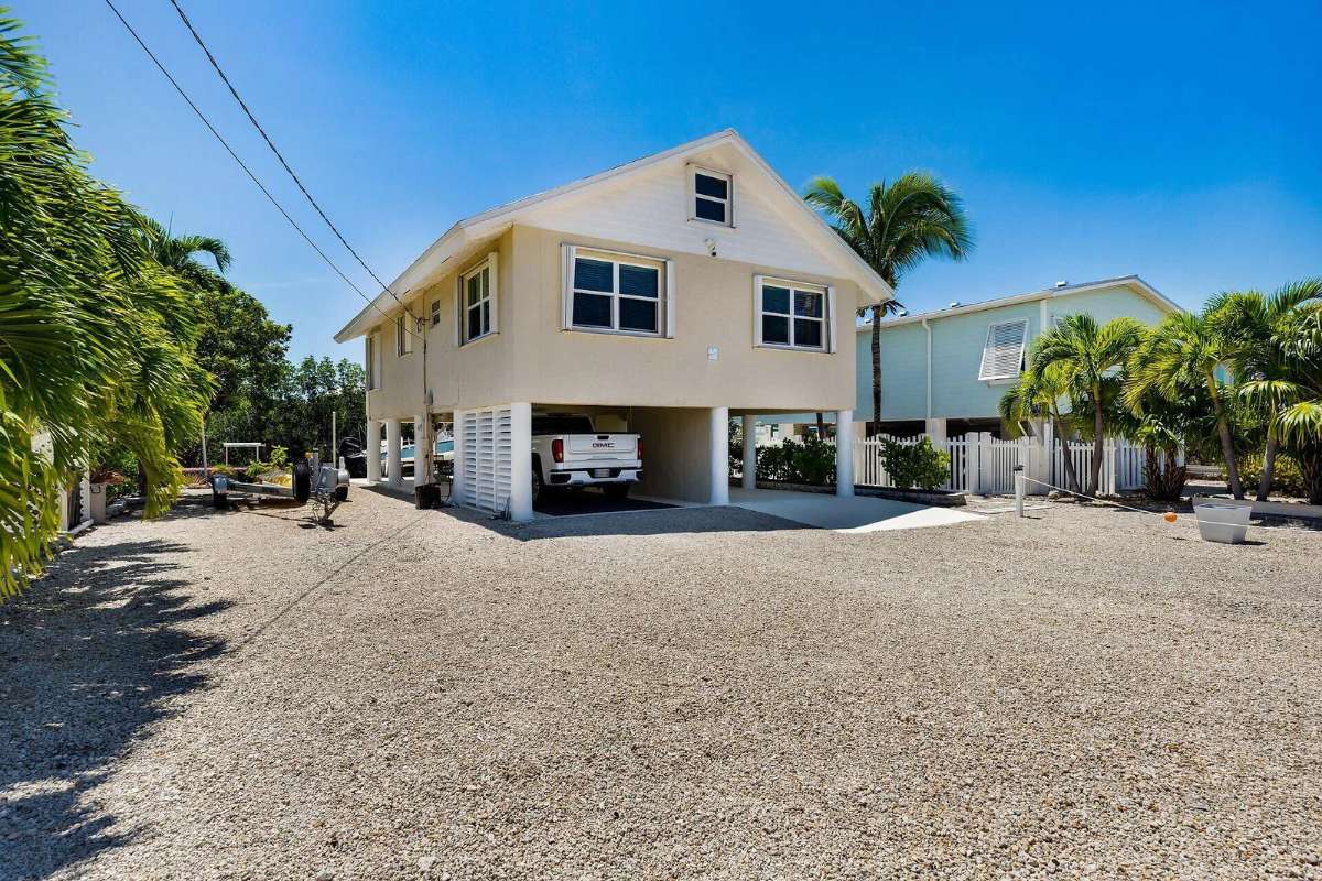 Raised canalfront home at 27322 Saint Martin Ln in Breezeswept Beach Estates, Ramrod Key, Florida Keys