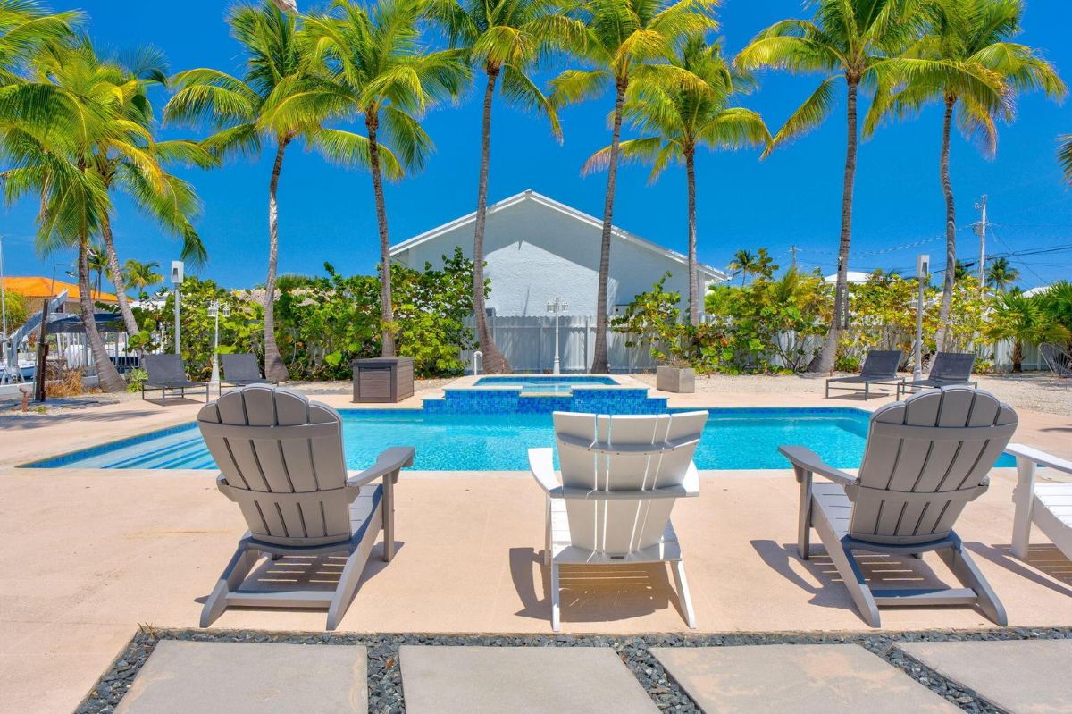 Heated pool and spa with palm trees at canalfront home in Port Largo, Key Largo, Florida Keys
