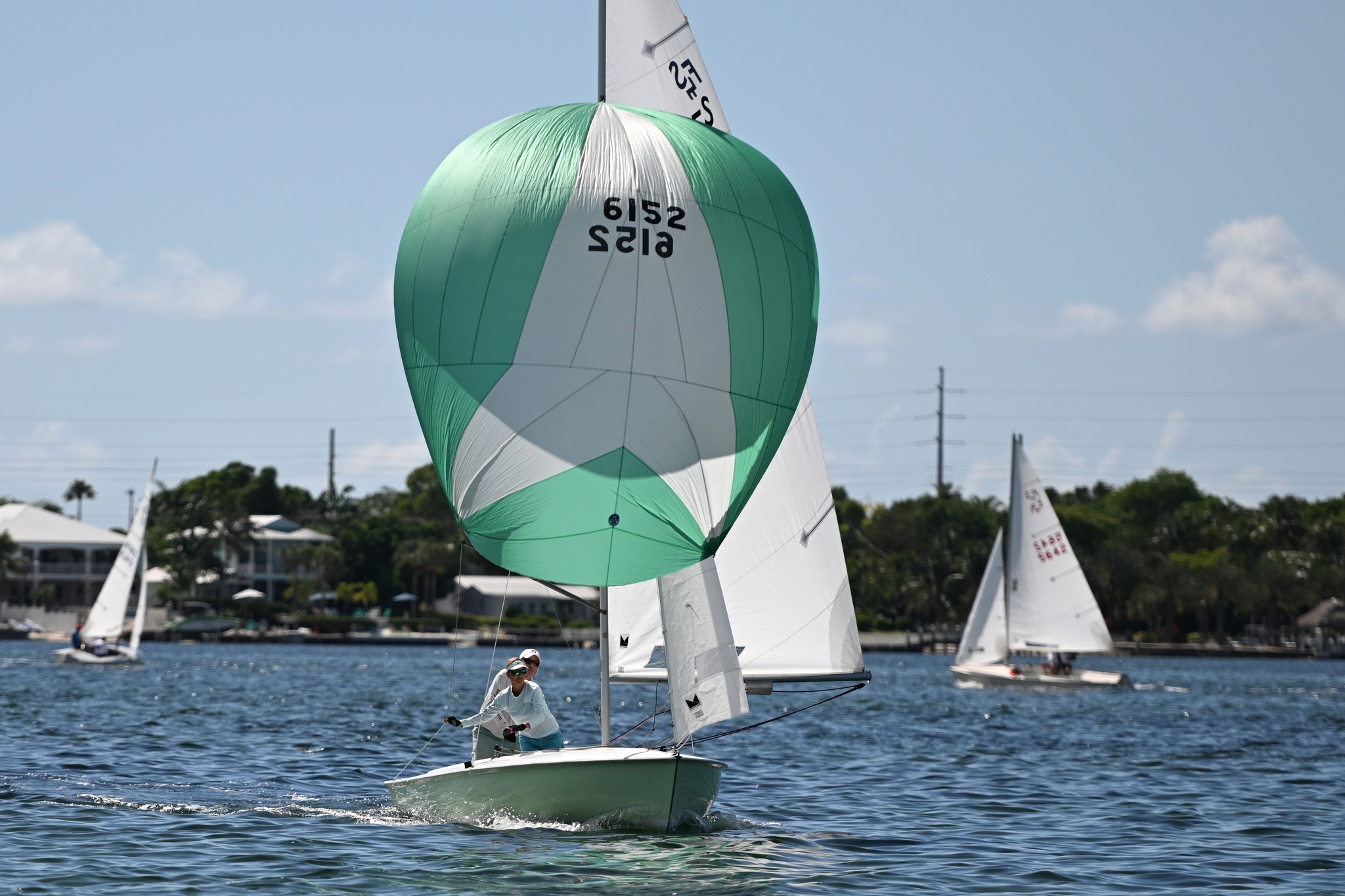 Jim Signor and his wife racing their Flying Scot under a green spinnaker on Buttonwood Sound near the Upper Keys Sailing Club in Key Largo