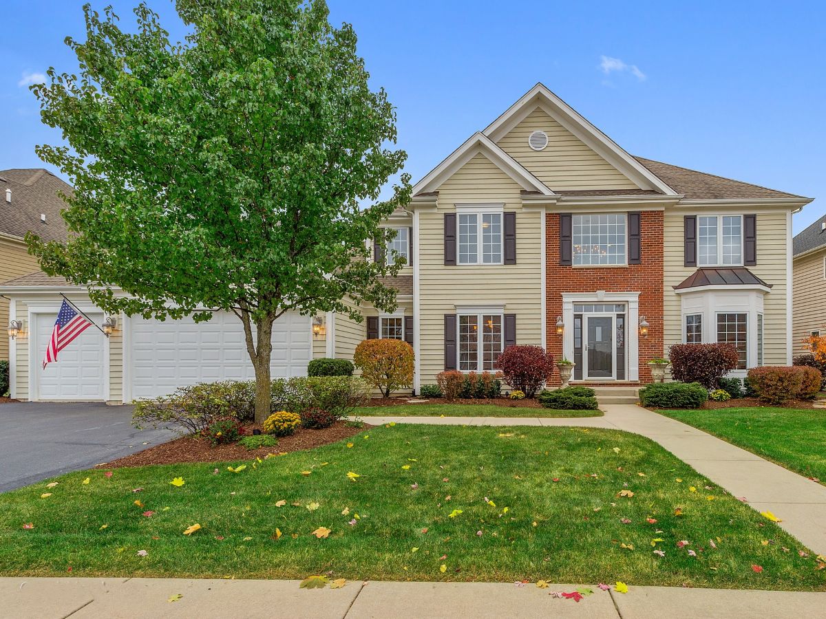 Two-story single-family home with a front yard in St. Charles, IL