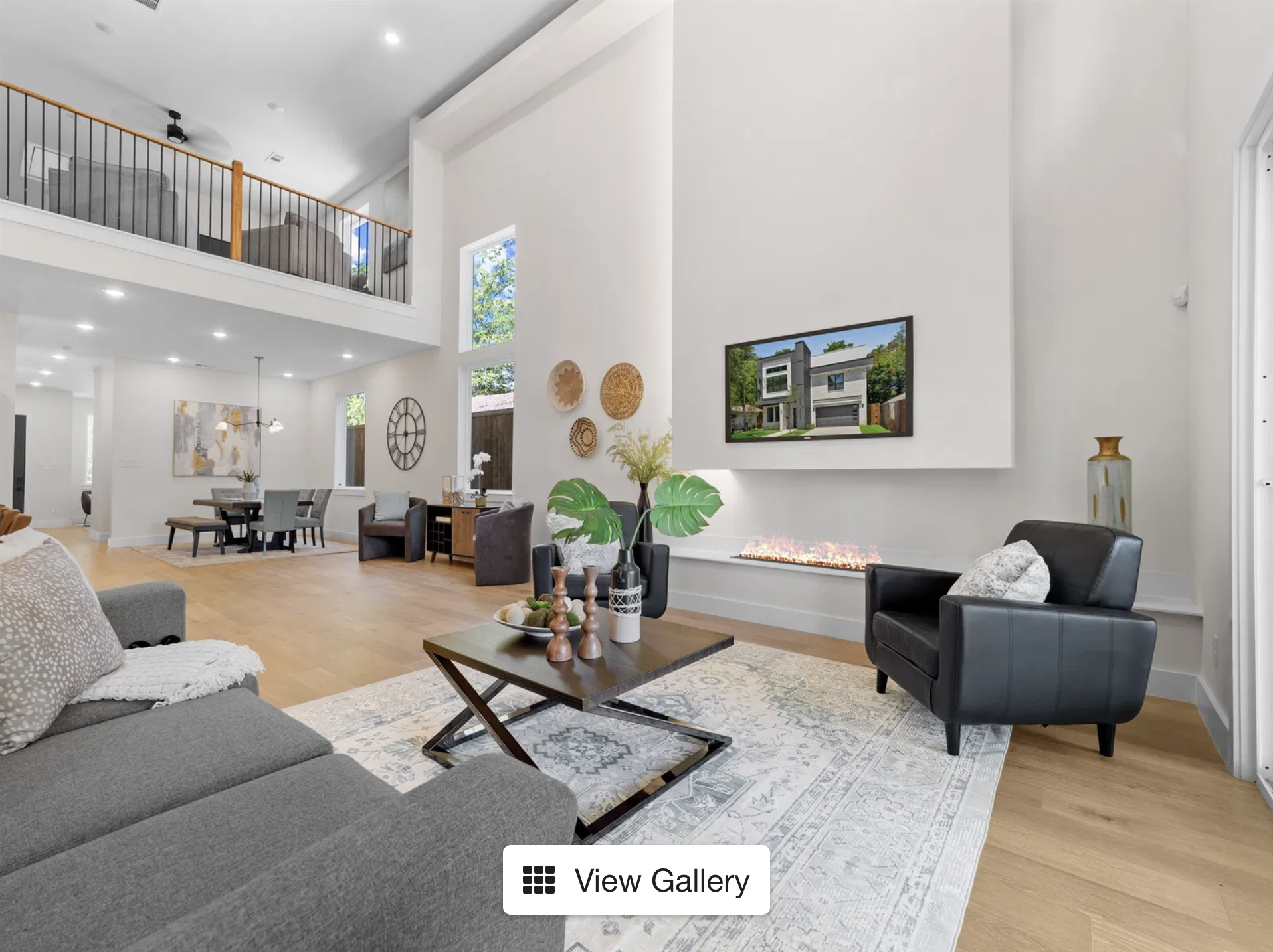 Soaring 20-ft double-height ceilings in open living room at 416 Mt Auburn Ave