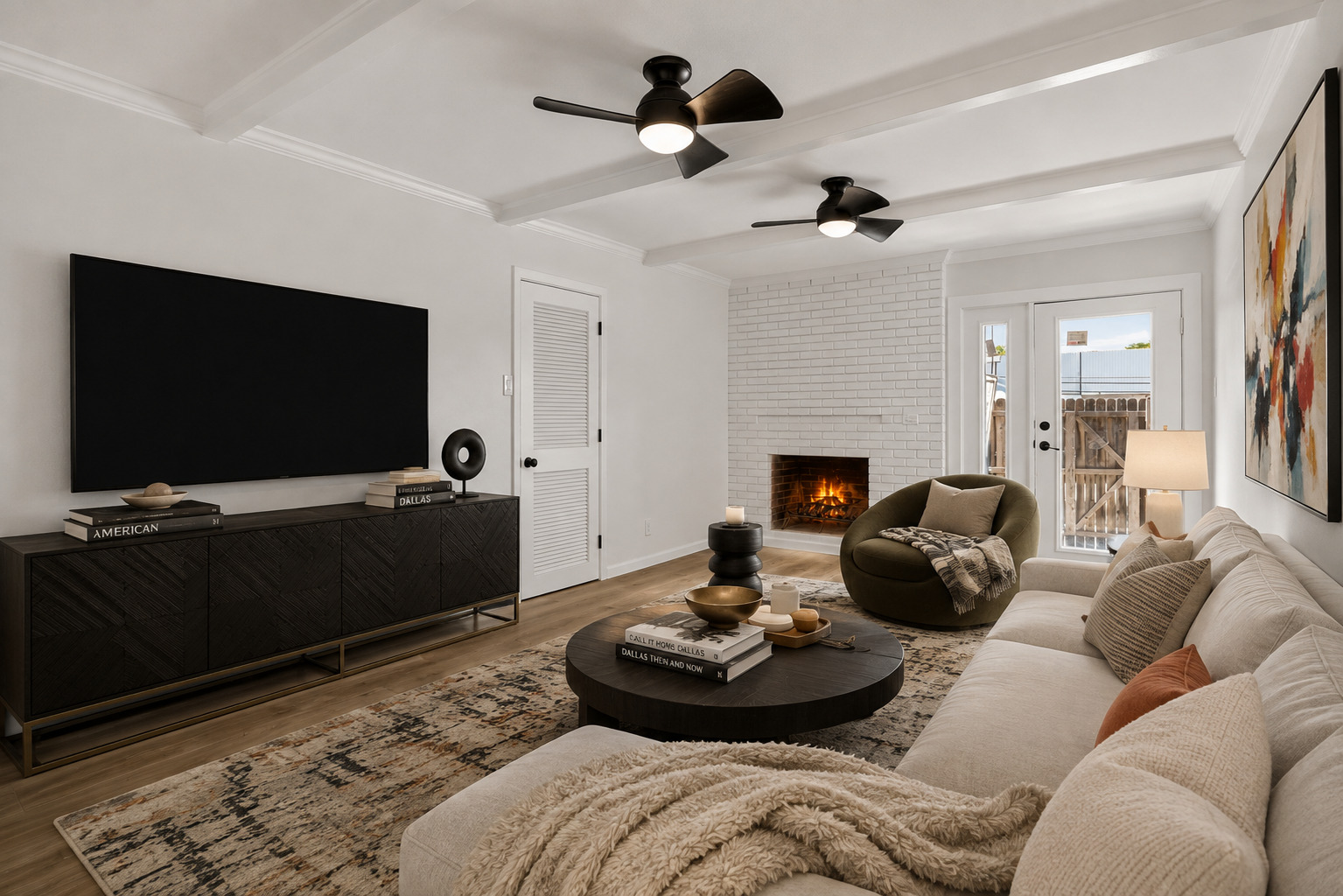 Living room with white brick fireplace and beam ceilings at 6020 E University Blvd Unit 117 Dallas