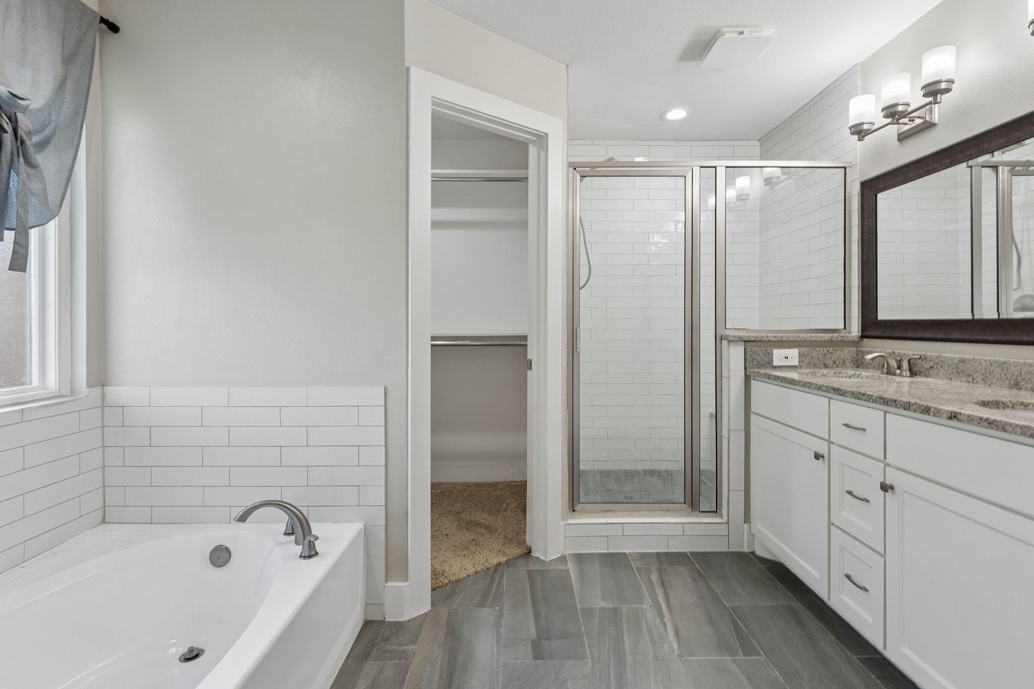Primary bath with soaking tub and separate shower at 7406 Bayview Drive