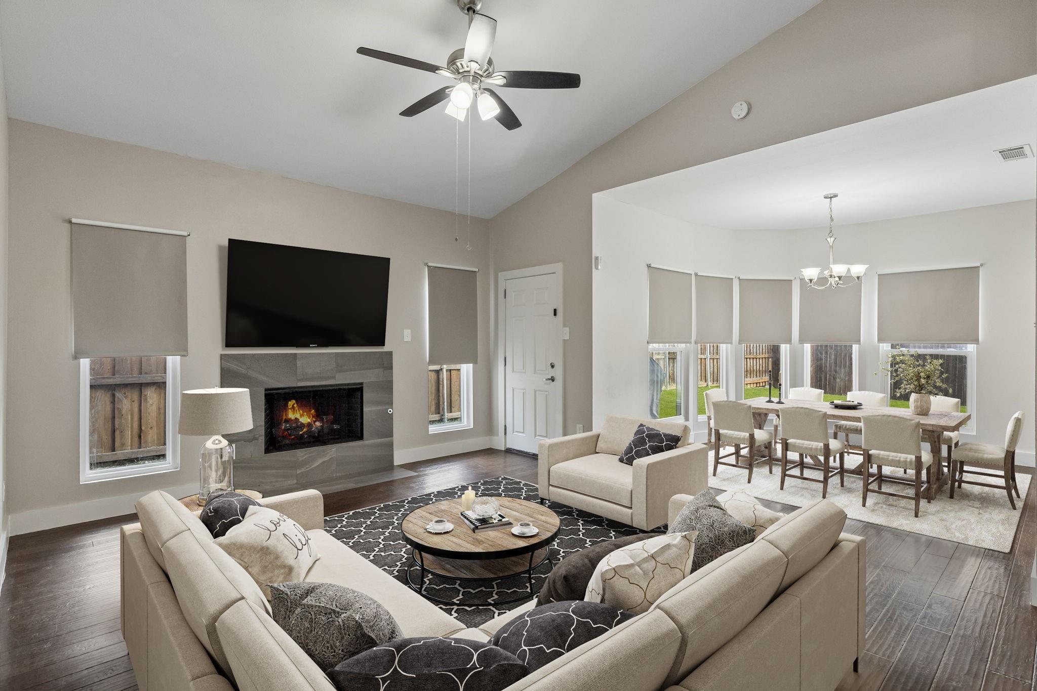 Open concept living room with fireplace and hardwood floors at 7406 Bayview Drive Rowlett TX