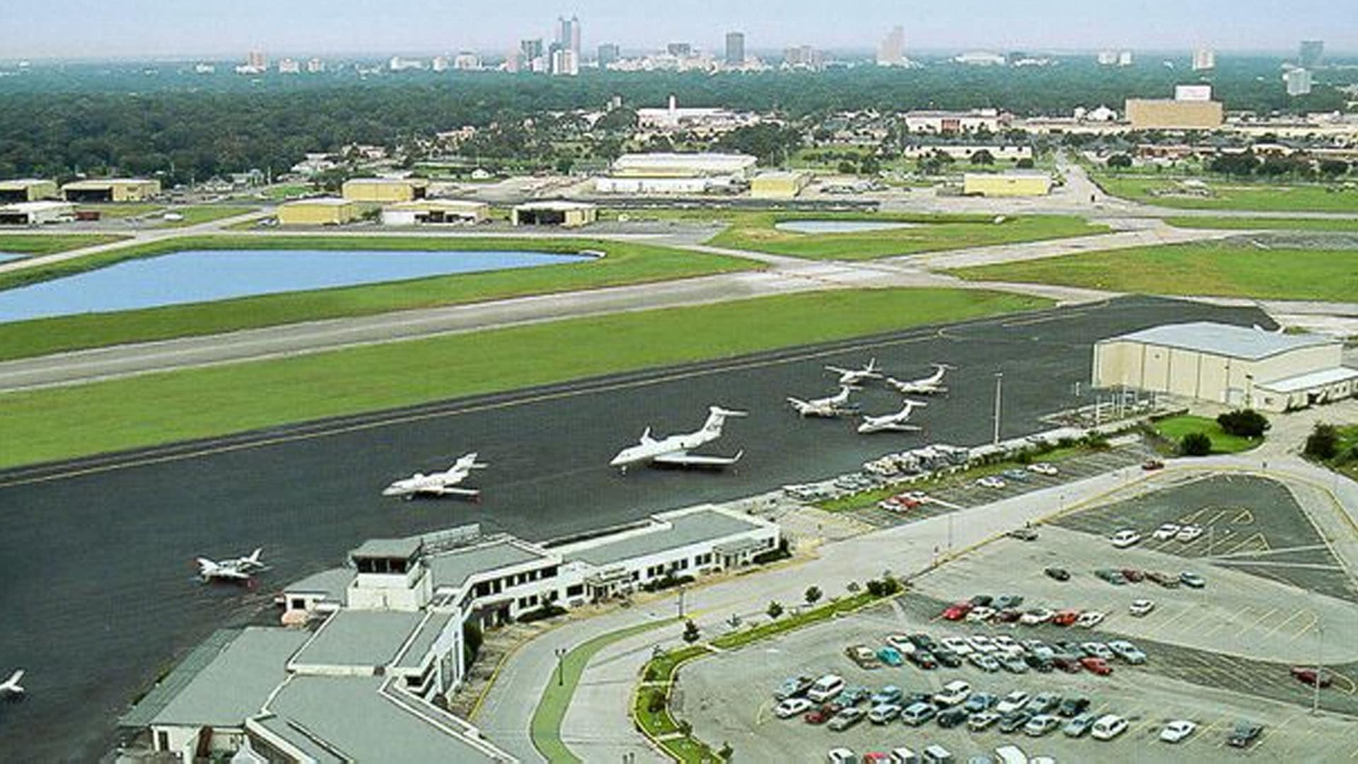 Business jets and small aircraft parked on the ramp at Orlando Executive Airport east of downtown Orlando