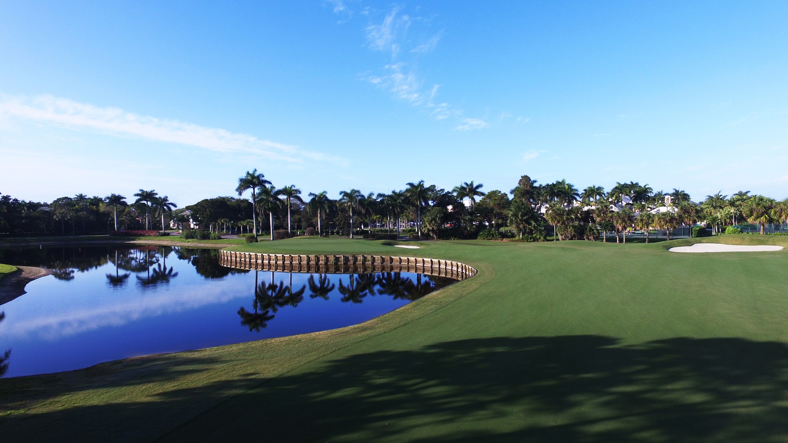 Exclusive golf course with palm trees and lake views in a Bonita Springs luxury community