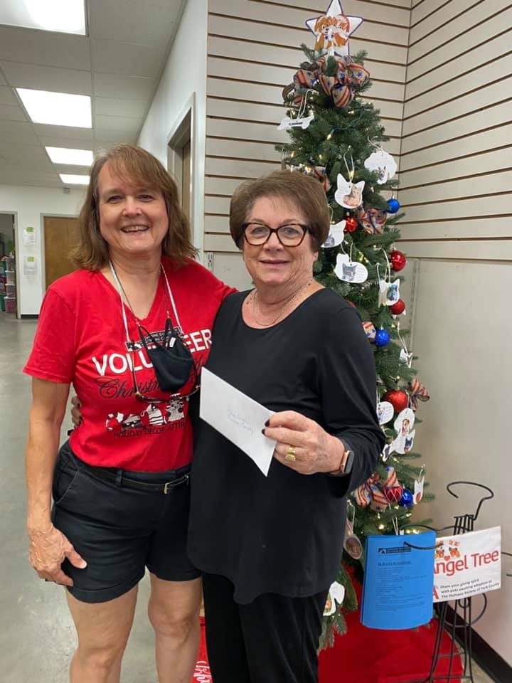 Linda Hall giving our friend, Santa's HEAD ELF, our annual donation.