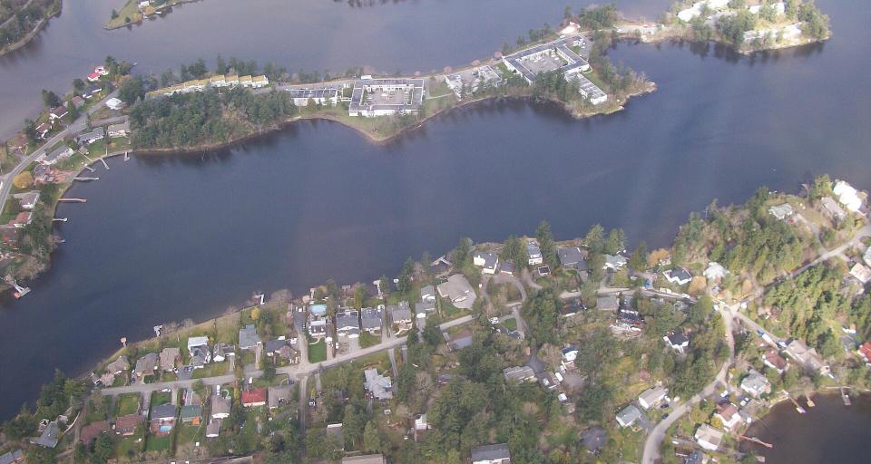 Aerial view of waterfront residential lots and streets on southern Vancouver Island