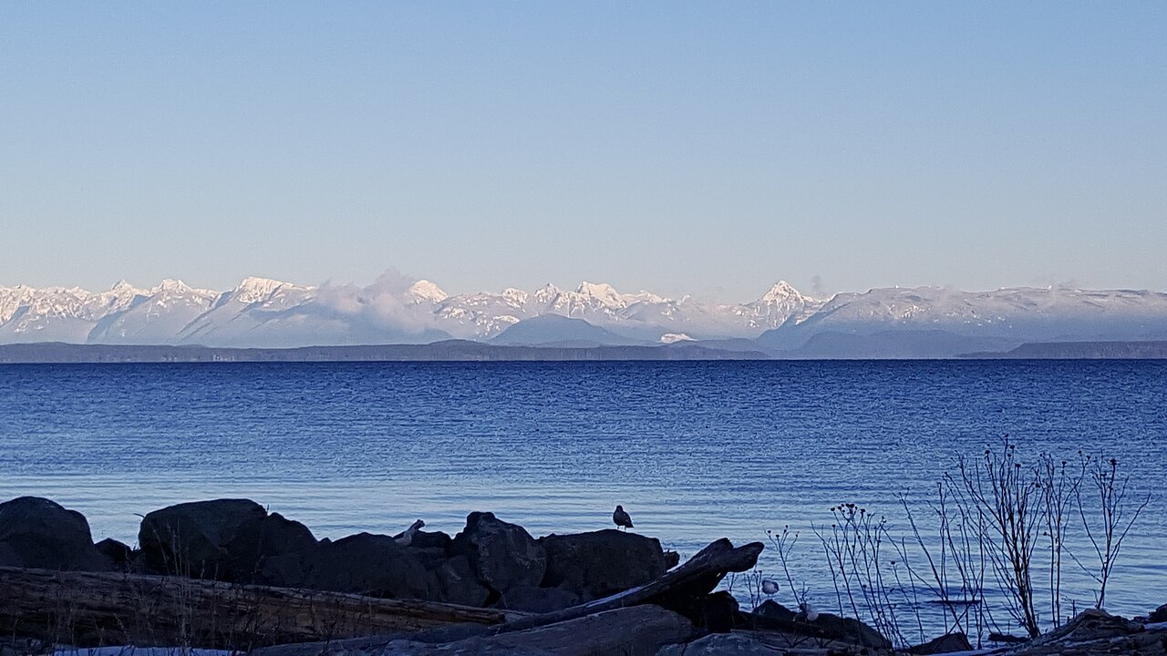 Discovery Passage from the Campbell River shore with snow-capped Coast Mountains on the horizon
