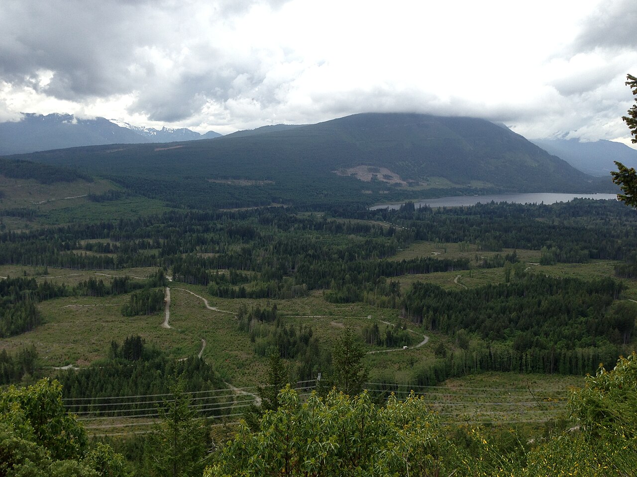 Open fields and forested hills in the valley at First Lake, one of the Nanaimo Lakes