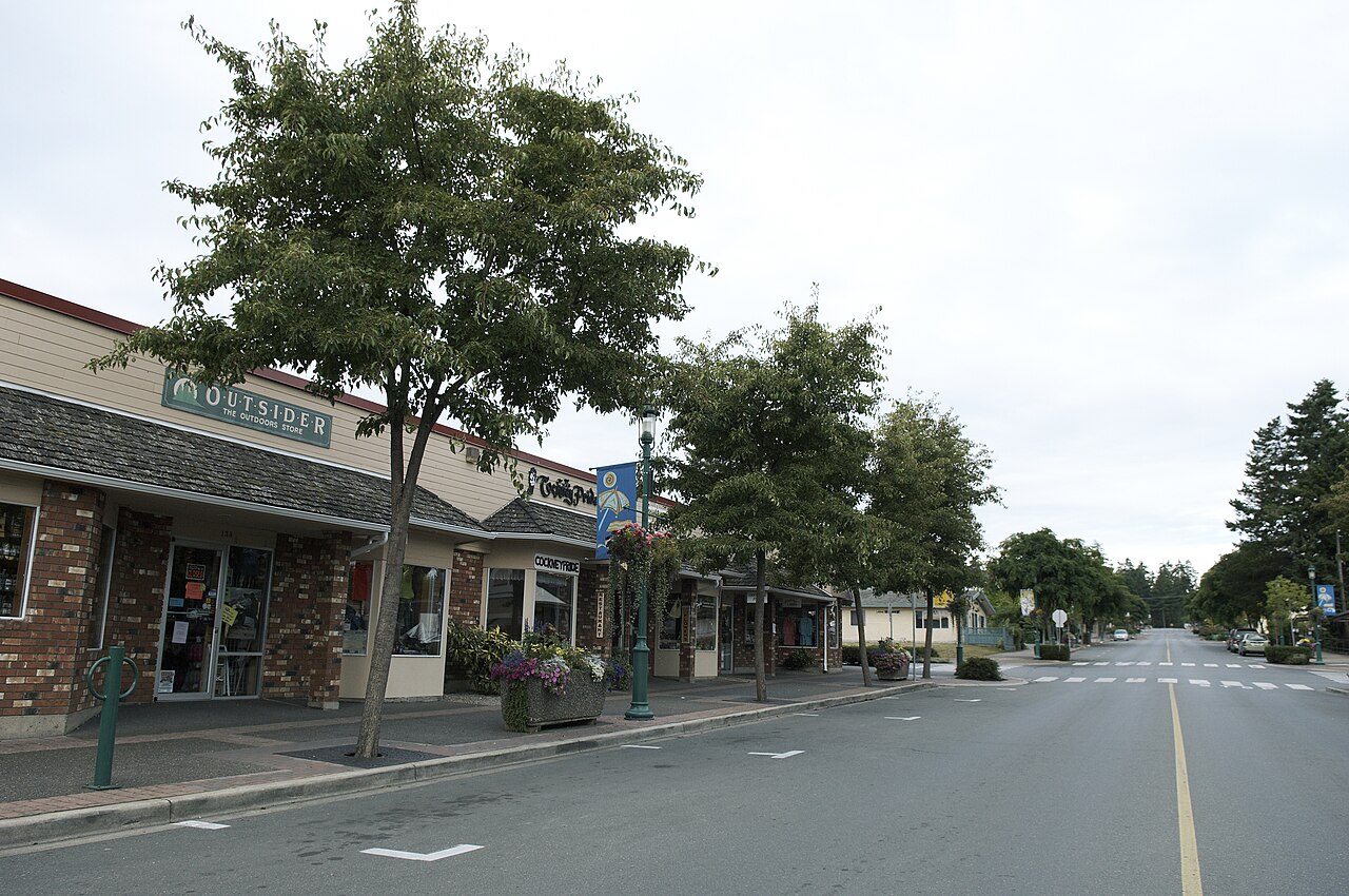 Tree-lined street with shops in the village centre of Qualicum Beach