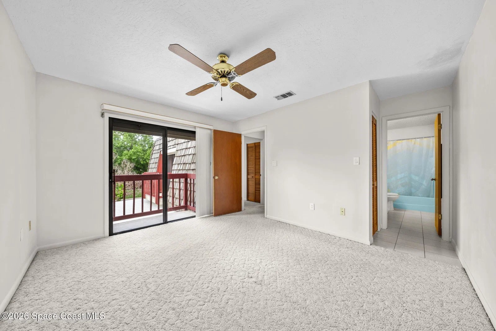 Upstairs bedroom with balcony door and private bath at 44 Piney Branch Way