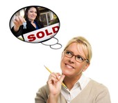 Woman thinking about a Surprise, AZ real estate purchase