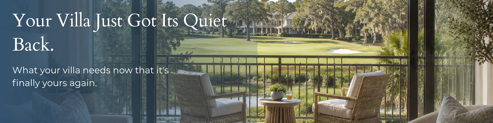 Private balcony of a Hilton Head villa overlooking a golf course and marsh, with wicker seating and a small side table set for a quiet afternoon