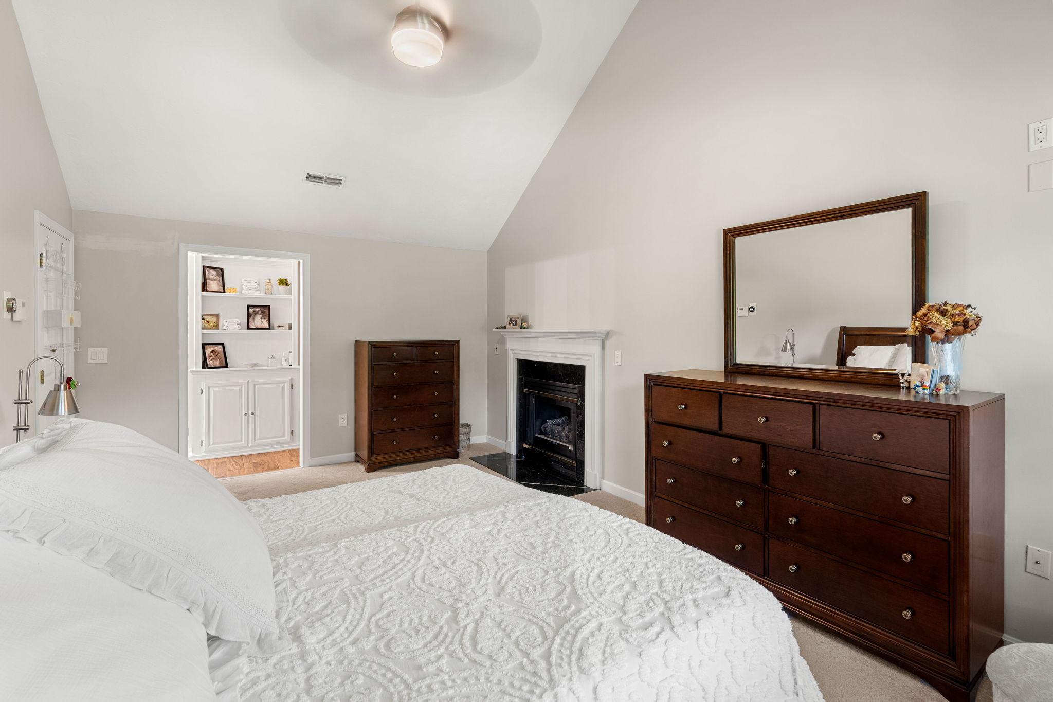 Primary bedroom suite with vaulted ceiling and walk-in closet at 10 Captain Circle Tewksbury