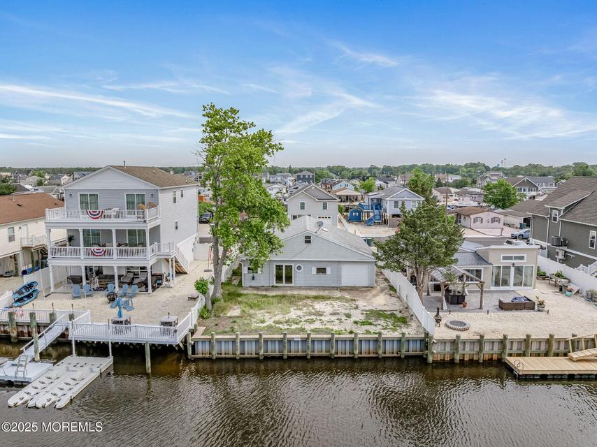 Aerial view of a Jersey Shore lagoon with older and newer homes along the bulkhead