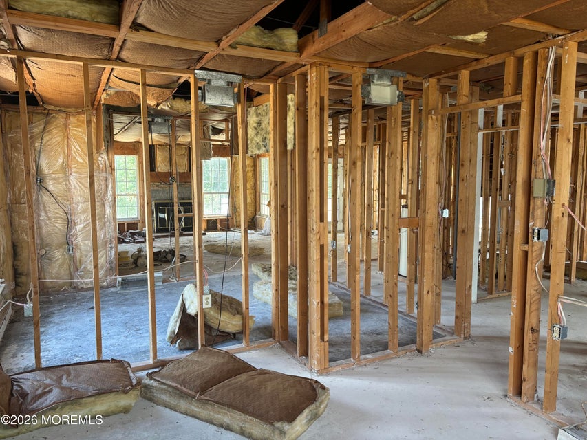 Interior of a gutted house with walls opened to the studs and wiring exposed