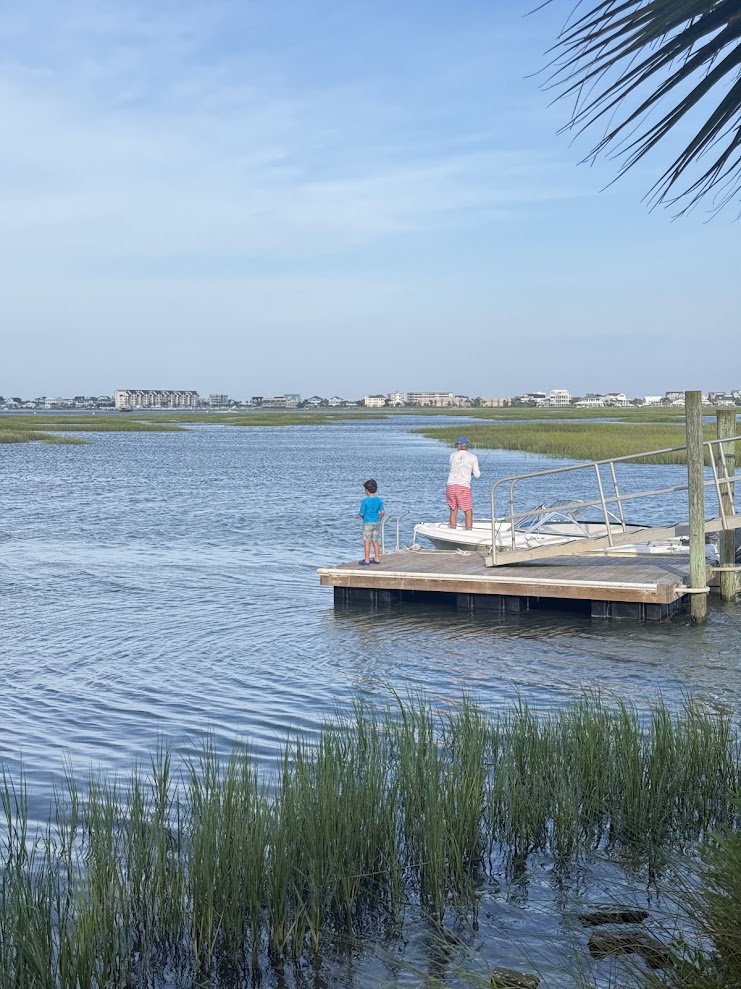 Two people enjoying a private dock beside the Murrells Inlet salt marsh