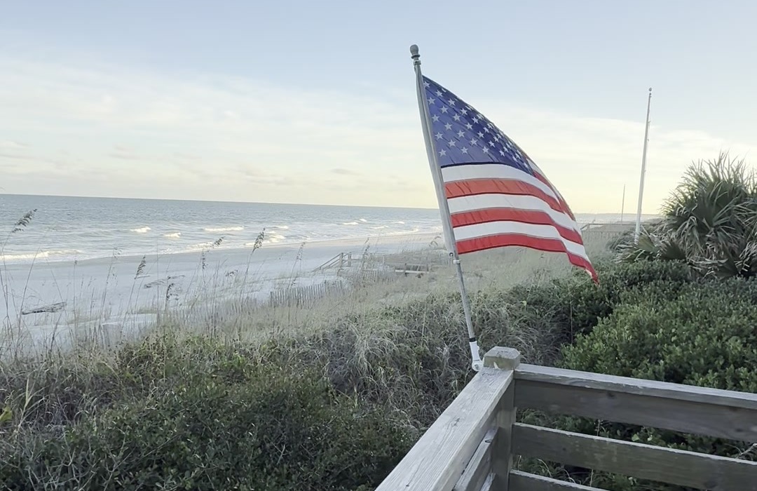 American flag above the dunes and Atlantic Ocean on Pawleys Island South Carolina