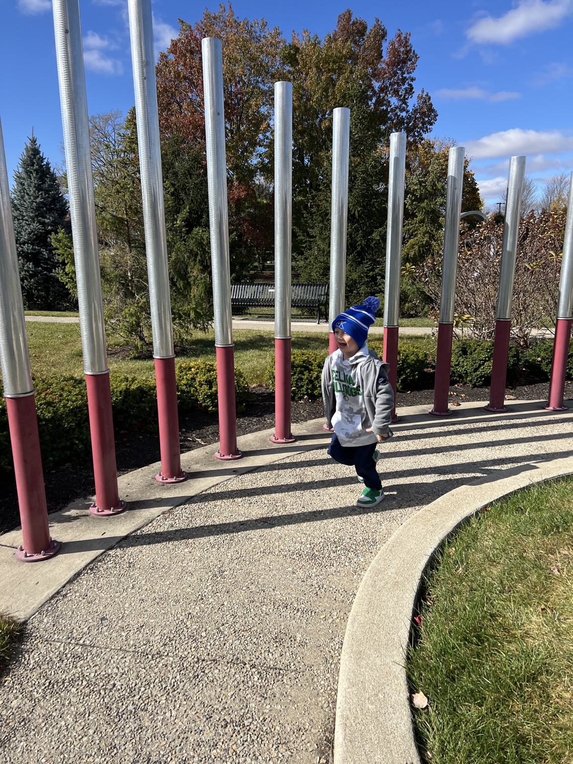 Child enjoying outdoor musical chimes in New Bremen Ohio