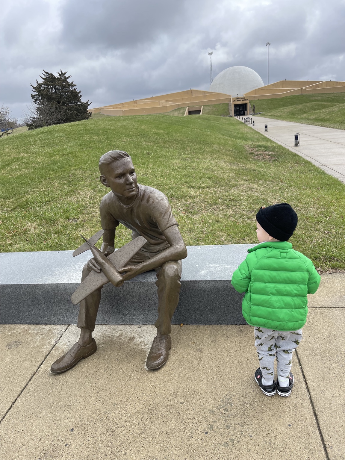 Child near the Neil Armstrong statue outside the Armstrong Air and Space Museum in Wapakoneta Ohio