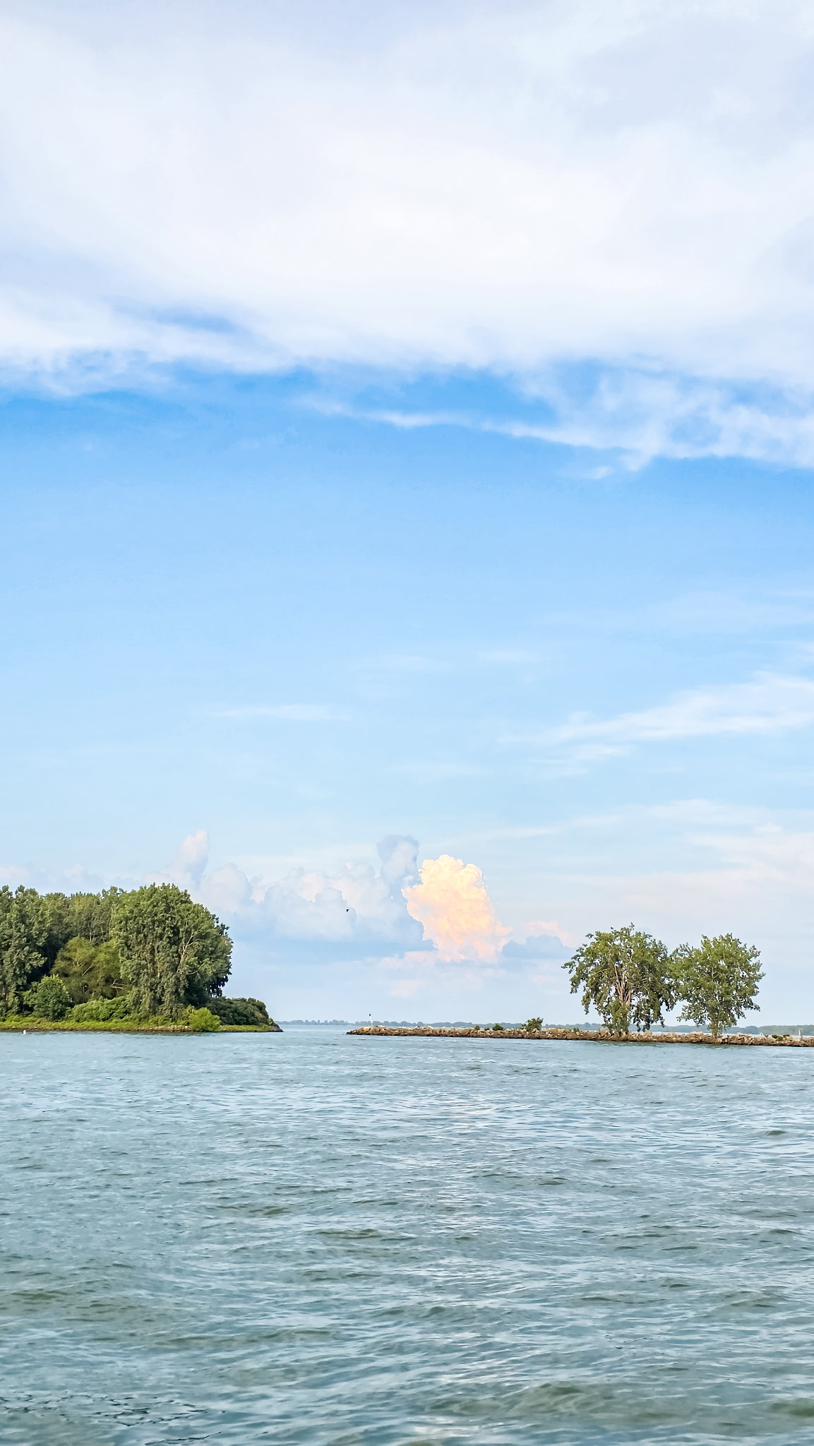 Small tree-covered islands and clouds over Grand Lake St. Marys