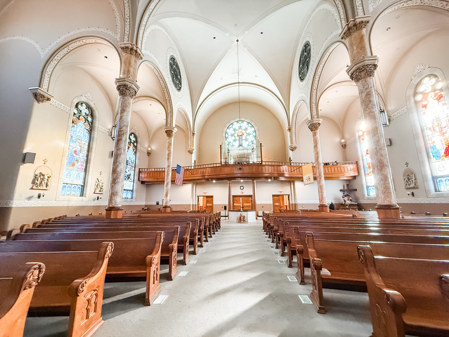 View toward the rear organ loft and stained glass at Immaculate Conception Church