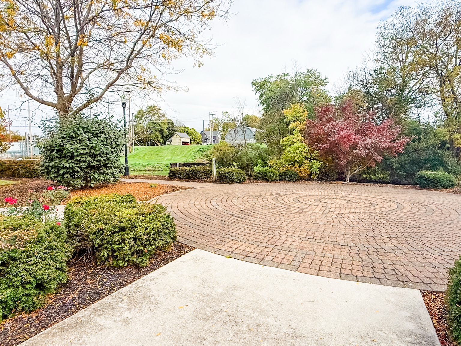 Circular brick labyrinth surrounded by autumn landscaping in St. Marys