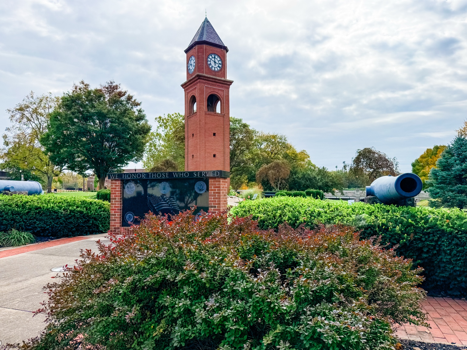 Red brick veterans memorial clock tower with cannons in St. Marys Ohio
