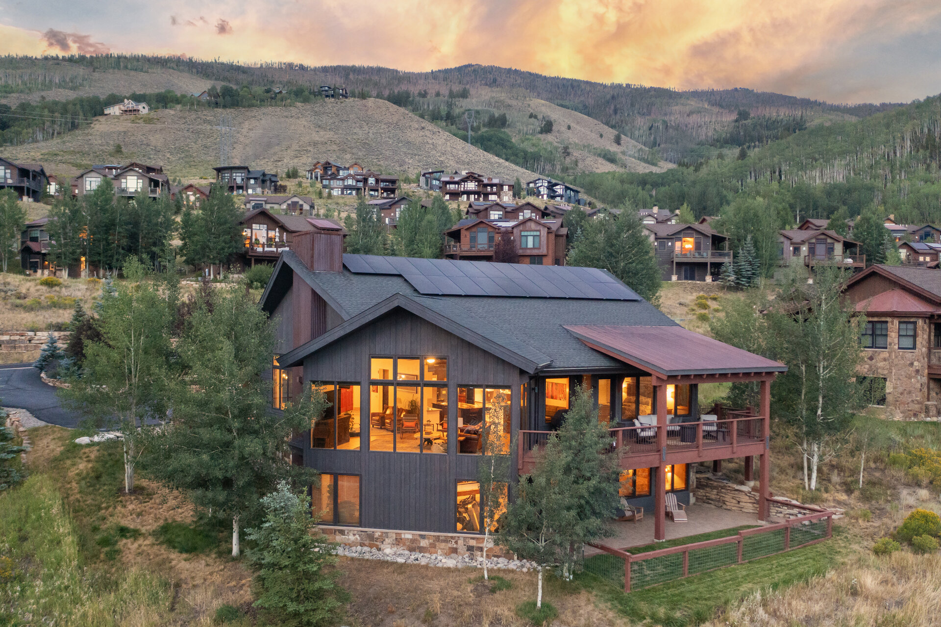 The home at twilight with the Gore Range behind it