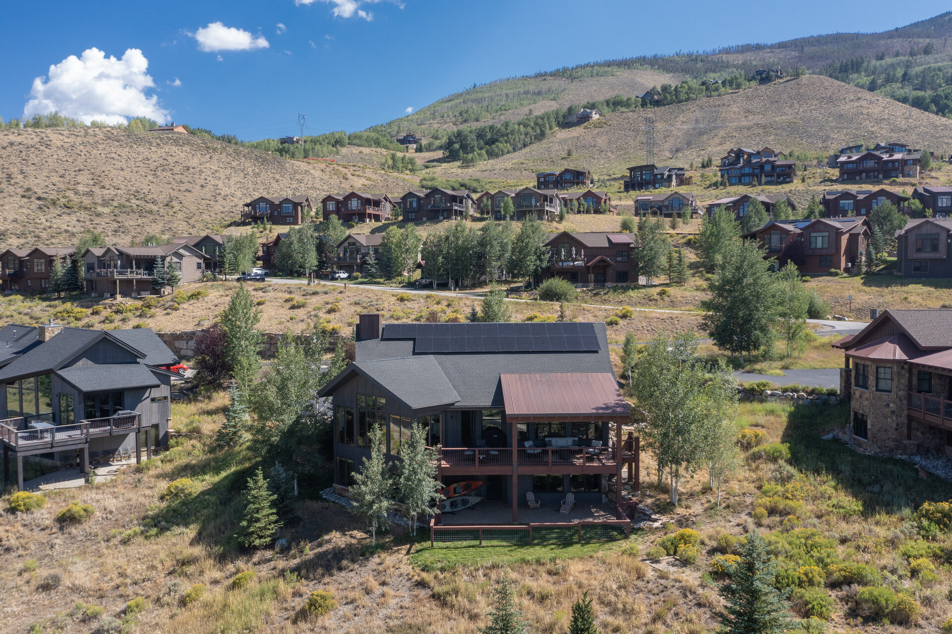 Aerial of the home with solar roof and the range