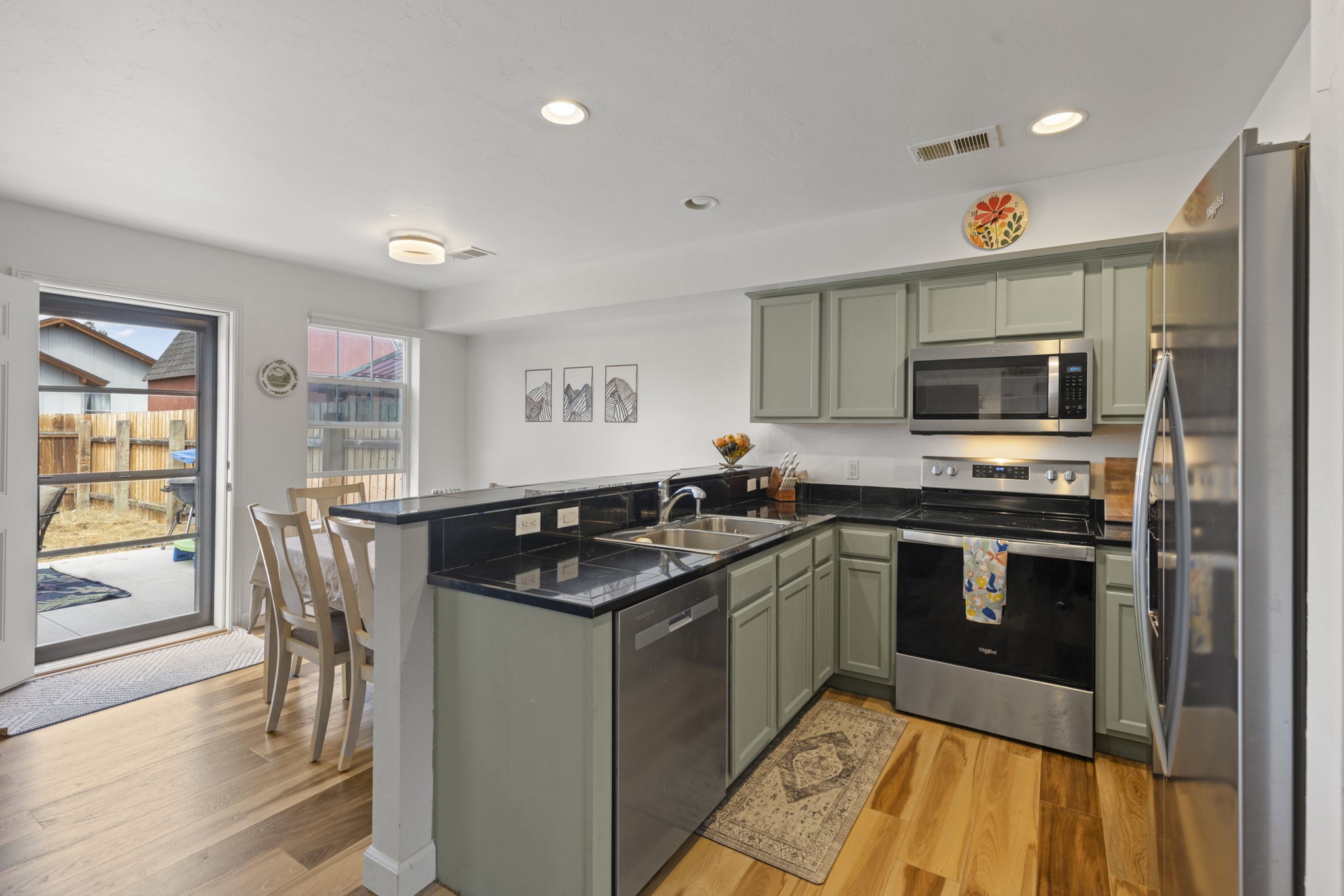 Kitchen with green cabinetry and dark counters at 509 N 12th Street A