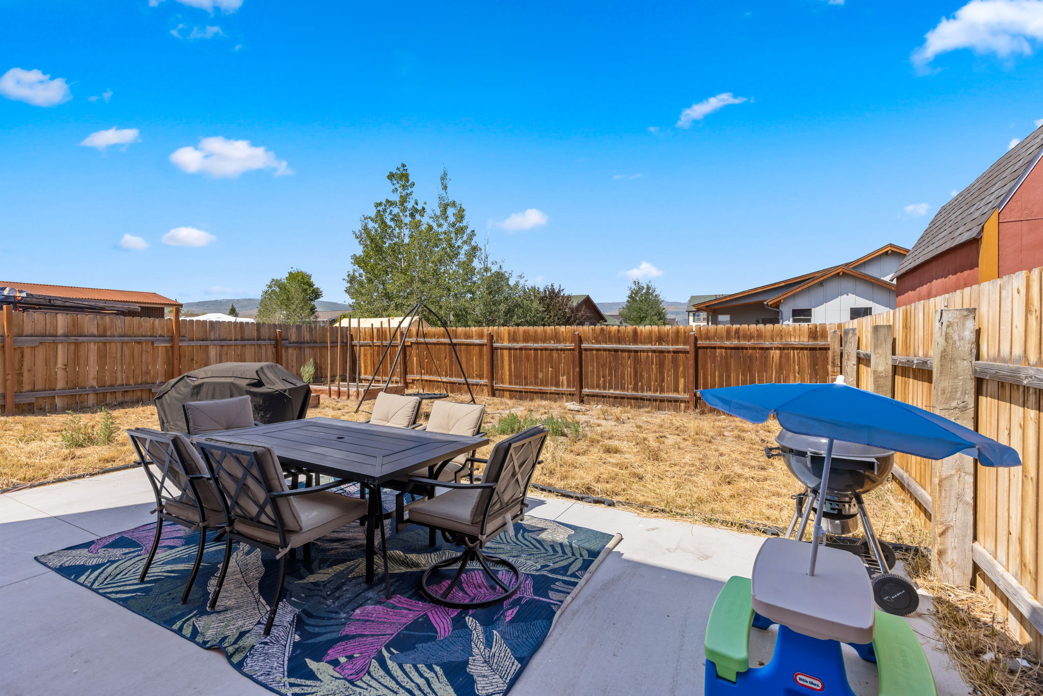 Patio dining space in the fenced backyard of the Kremmling home