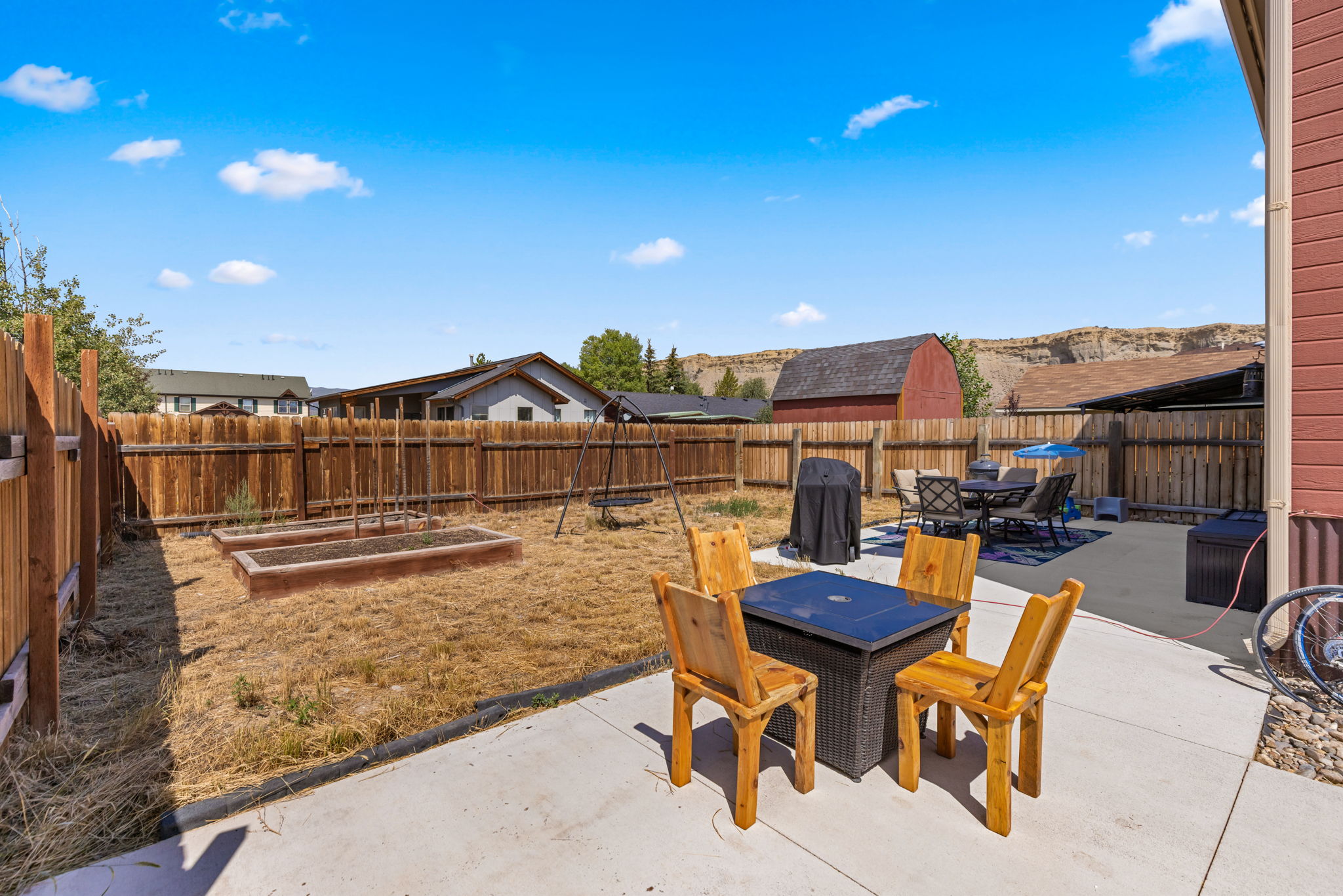 Backyard seating area near raised garden beds in Kremmling