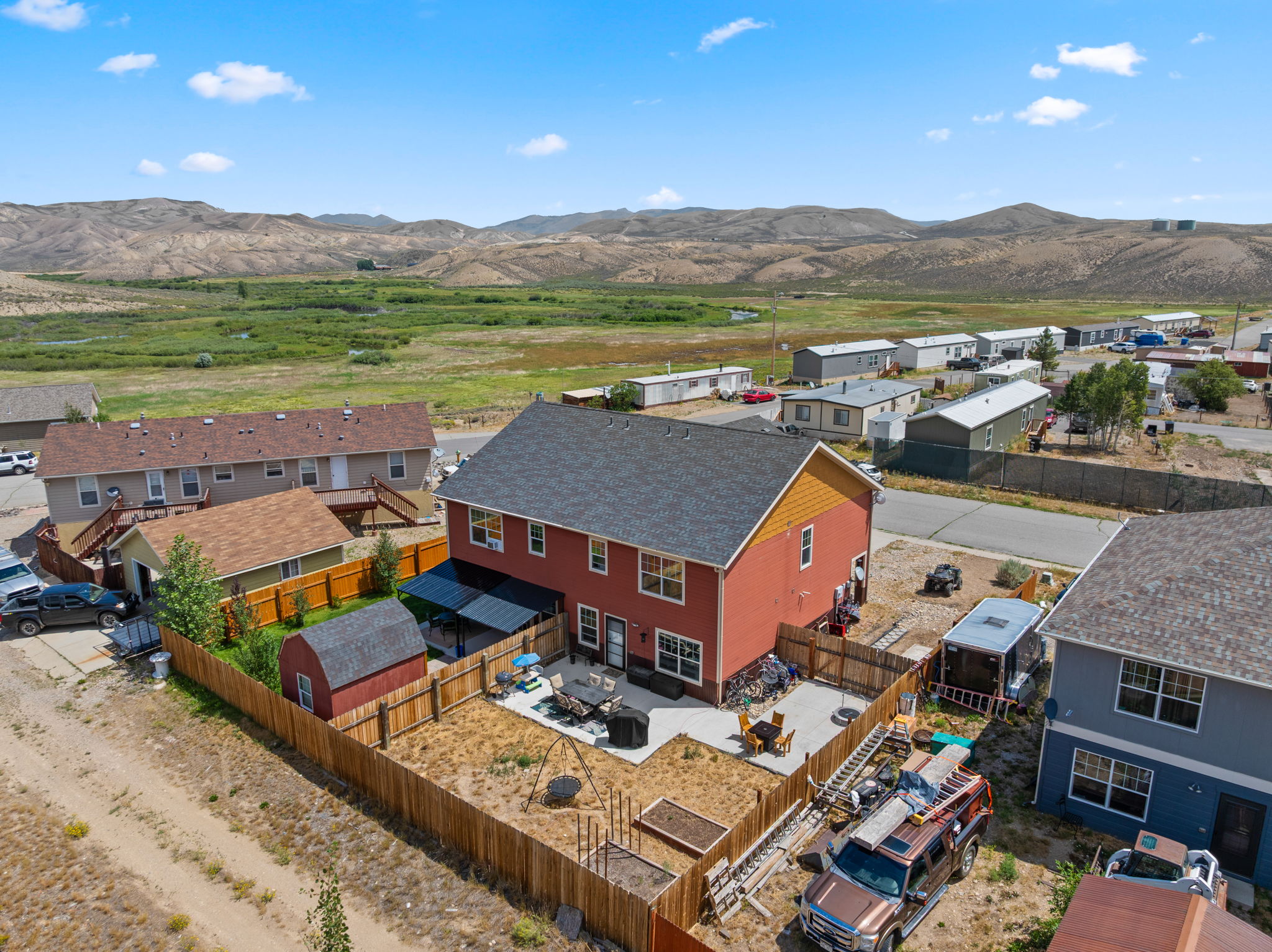 Aerial view of the home in its Kremmling neighborhood with mountain backdrop