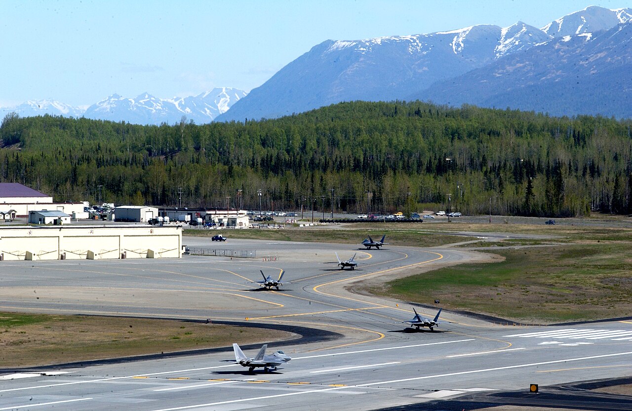 F-22 Raptors taxiing at Elmendorf Air Force Base, now Joint Base Elmendorf-Richardson, with the snow-capped Chugach Mountains behind