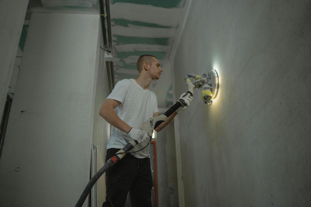 Man making repairs inside a house