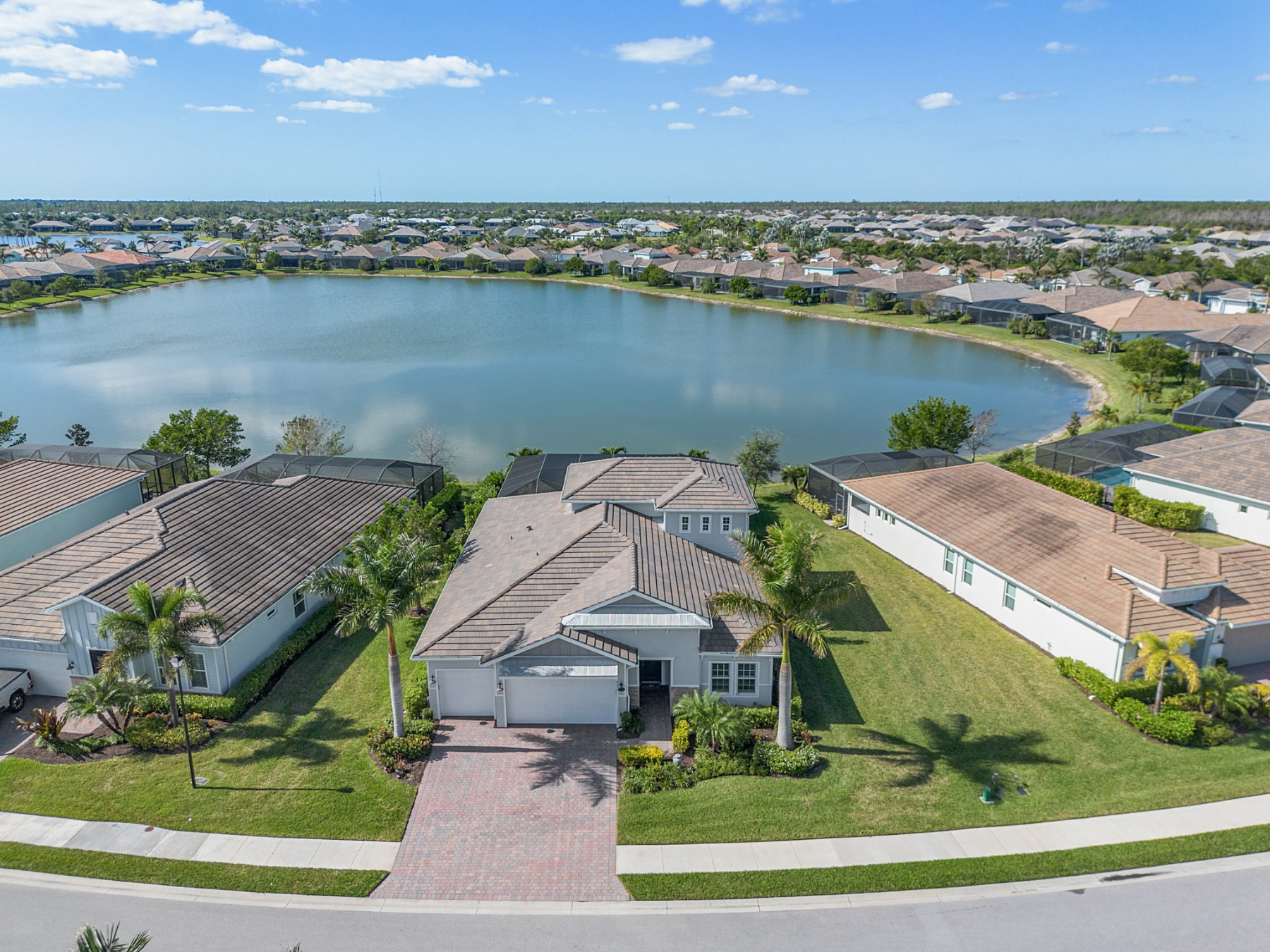 Naples gated community with homes, lake views, and landscaped streets