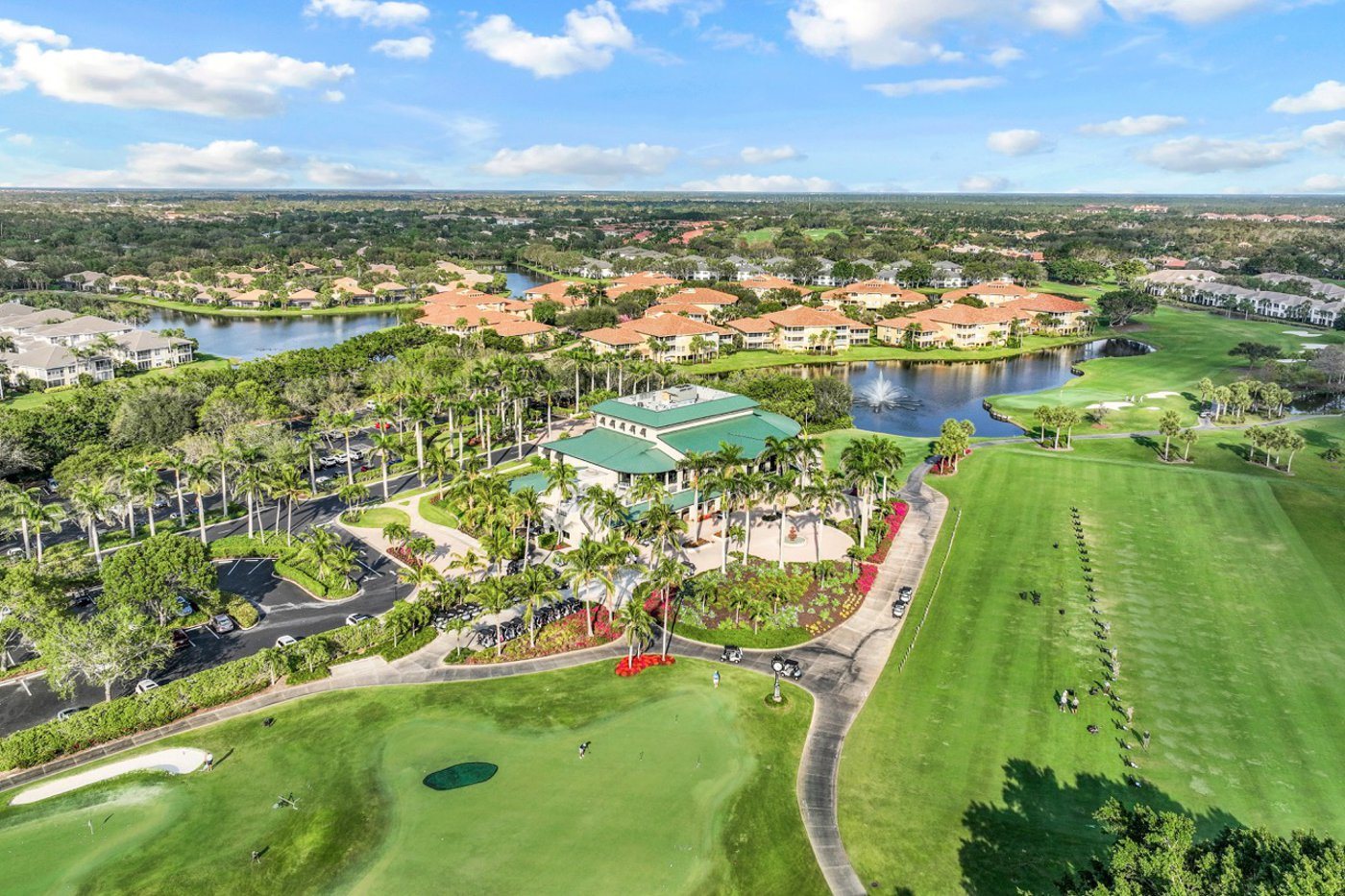 Aerial view of the Pelican Marsh clubhouse, golf course, and surrounding homes in North Naples, Florida