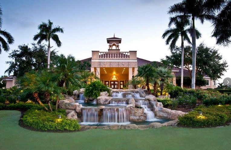 Clubhouse entrance and waterfall at Vasari Country Club, a bundled golf community in Bonita Springs, Florida