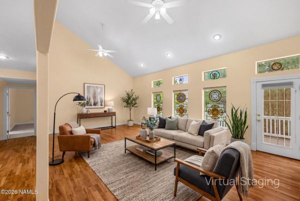 Formal living room with stained-glass windows and hardwood floors in Walnut Ridge Flagstaff luxury home