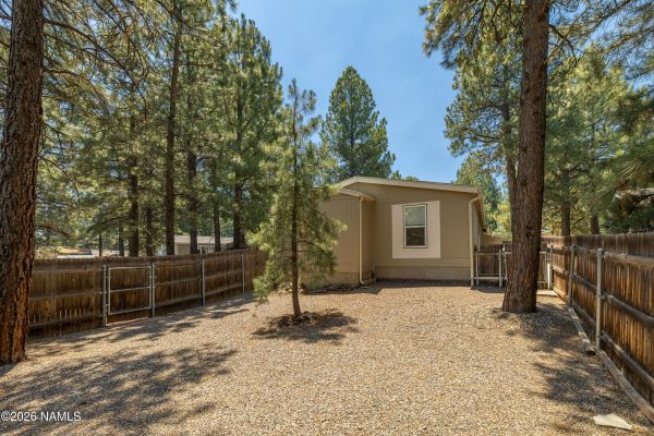 Fully landscaped, partially fenced backyard with drip irrigation at 2460 W Rio Grande Ct, Railroad Springs, Flagstaff, AZ