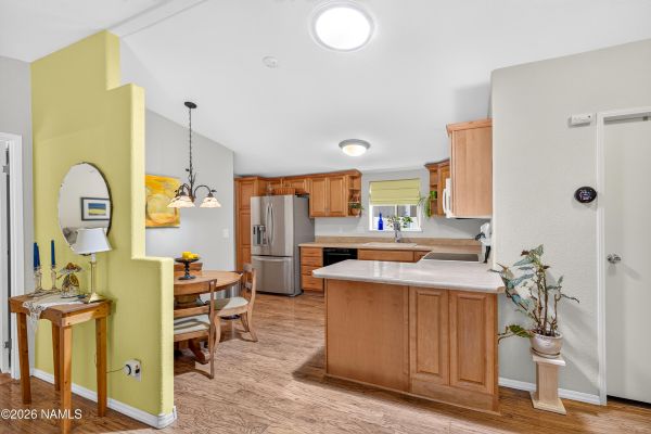 Open great-room layout with upgraded laminate flooring and kitchen cabinetry at 2460 W Rio Grande Ct in Flagstaff, AZ